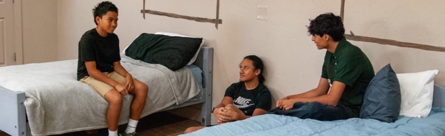 Oasis boys sitting in dorm room 900x275